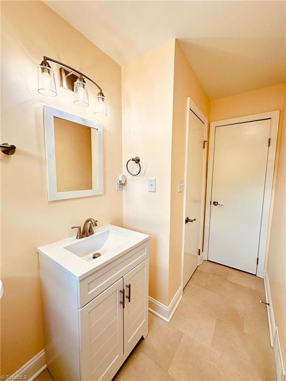 5670 Plantation Dr, Winston-Salem, NC 27105 - bathroom featuring baseboards and vanity