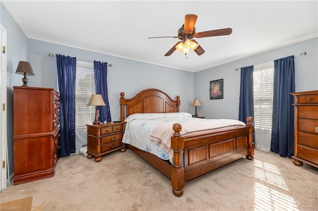 bedroom featuring ceiling fan, light colored carpet, and ornamental molding