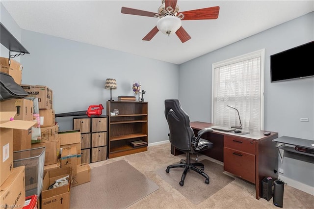 carpeted office featuring ceiling fan