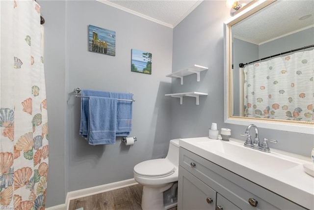 bathroom featuring ornamental molding, toilet, hardwood / wood-style floors, and vanity