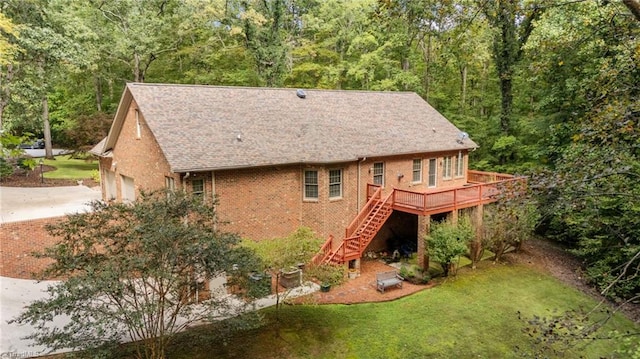 rear view of house featuring a deck and a lawn