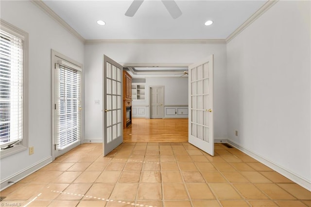 spare room with french doors, ceiling fan, and light tile patterned floors