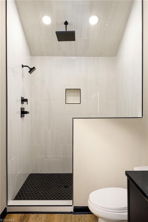6376 Welborn Rd, Trinity, NC 27370 - bathroom featuring walk in shower, vanity, and wood finished floors