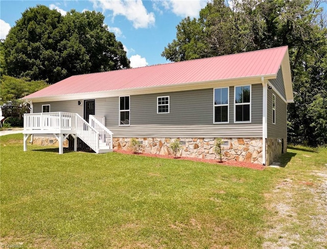 6376 Welborn Rd, Trinity, NC 27370 - view of front facade with a wooden deck, a front lawn, a metal roof, and stone siding