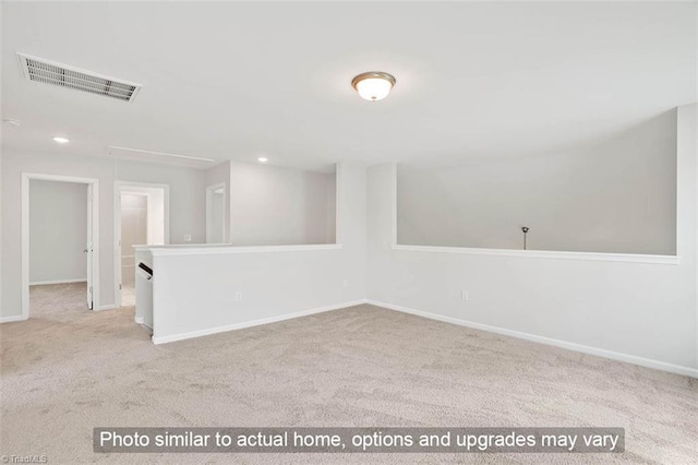 spare room with baseboards, visible vents, carpet floors, attic access, and recessed lighting