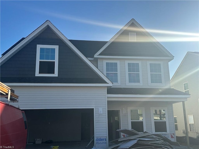 view of front facade featuring covered porch and a garage