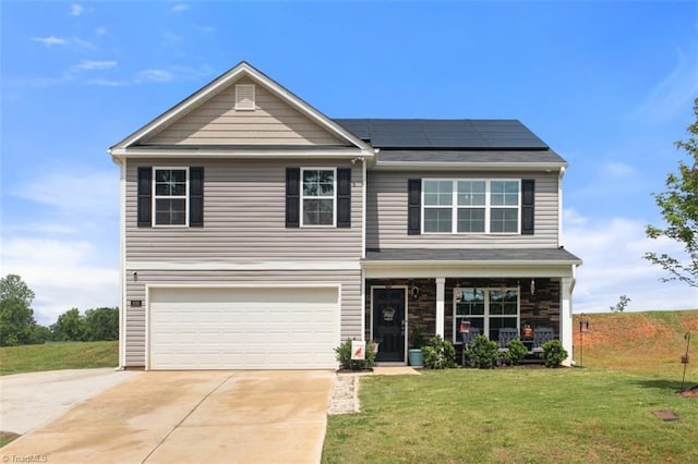 traditional-style home with solar panels, a porch, concrete driveway, an attached garage, and a front yard