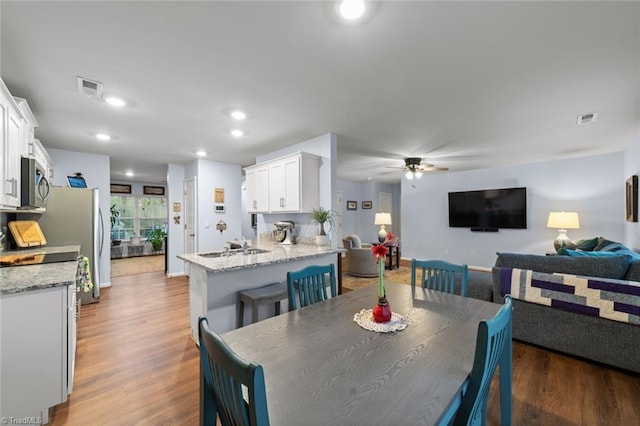 dining area with recessed lighting, visible vents, and wood finished floors