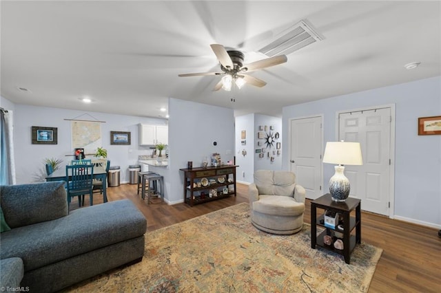 living area with recessed lighting, visible vents, a ceiling fan, wood finished floors, and baseboards