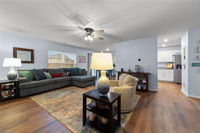 living room featuring dark wood-style flooring, recessed lighting, visible vents, ceiling fan, and baseboards