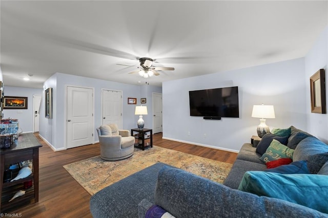 living area with dark wood finished floors, baseboards, and ceiling fan