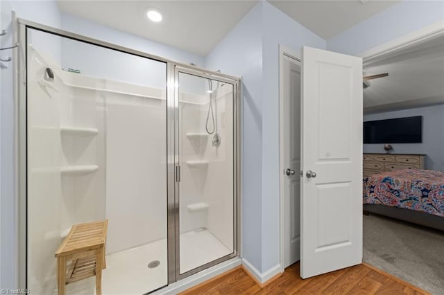 bathroom featuring a shower stall, wood finished floors, and ensuite bathroom