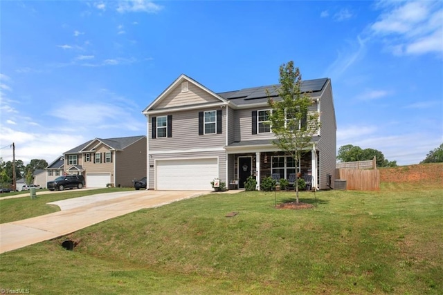 traditional-style home featuring a front yard, roof mounted solar panels, fence, a garage, and driveway