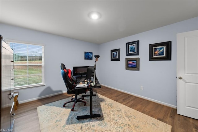 home office featuring baseboards and wood finished floors