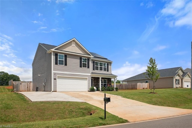 traditional home featuring driveway, fence, a front lawn, and solar panels