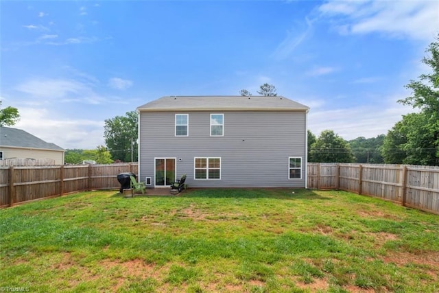 back of house with a patio area, a fenced backyard, and a yard