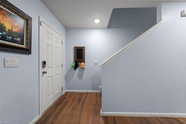 entryway with stairway, wood finished floors, and baseboards