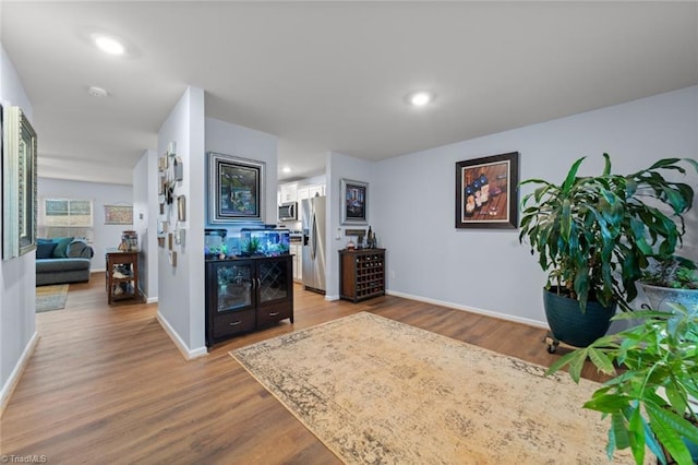 interior space with recessed lighting, baseboards, and wood finished floors