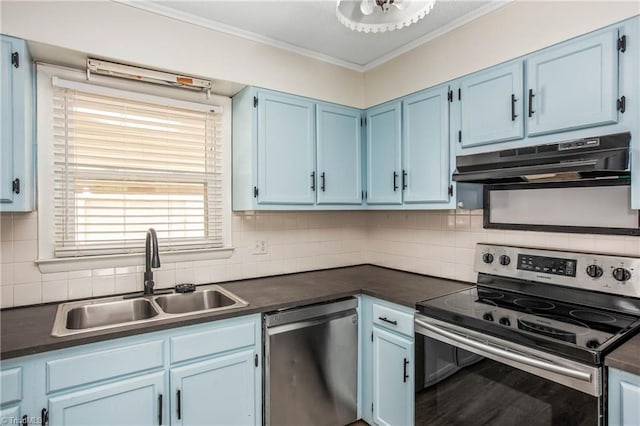 kitchen with dark countertops, appliances with stainless steel finishes, a sink, blue cabinetry, and under cabinet range hood