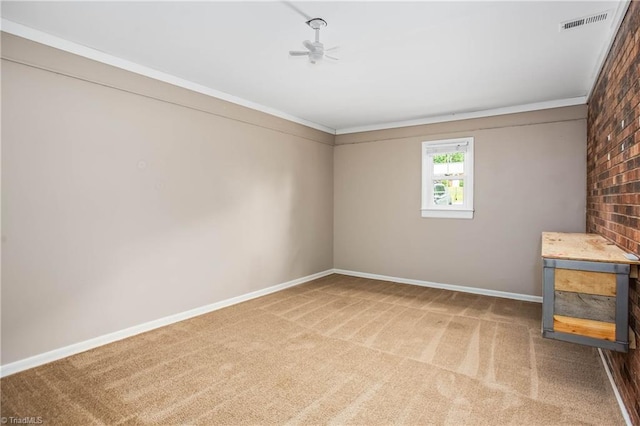 interior space with carpet flooring, ceiling fan, baseboards, visible vents, and ornamental molding