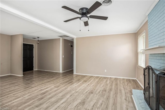 unfurnished living room with baseboards, visible vents, and light wood finished floors