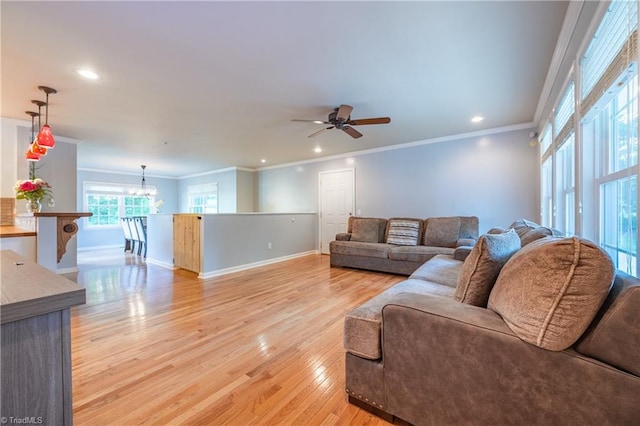 3289 Tobaccoville Rd, Tobaccoville, NC 27050 - living room with light wood-style floors, baseboards, ornamental molding, and ceiling fan with notable chandelier