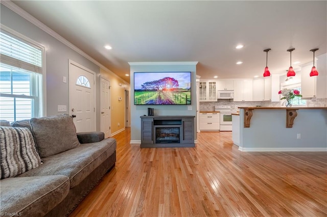 3289 Tobaccoville Rd, Tobaccoville, NC 27050 - living room featuring baseboards, a fireplace, crown molding, recessed lighting, and light wood-style flooring
