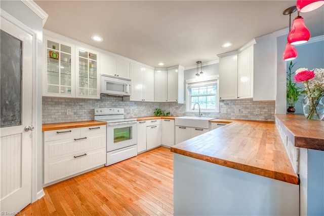 3289 Tobaccoville Rd, Tobaccoville, NC 27050 - kitchen featuring tasteful backsplash, wood counters, white appliances, light wood finished floors, and a sink
