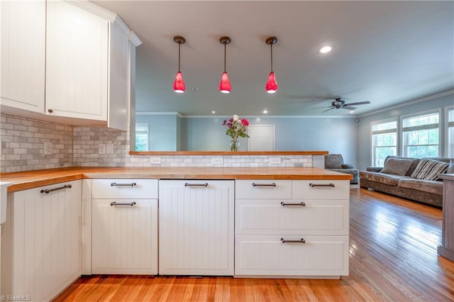 3289 Tobaccoville Rd, Tobaccoville, NC 27050 - kitchen with butcher block countertops, open floor plan, a ceiling fan, and backsplash