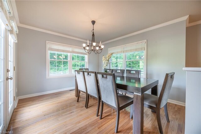 3289 Tobaccoville Rd, Tobaccoville, NC 27050 - dining area featuring a chandelier, light wood-style flooring, baseboards, and crown molding