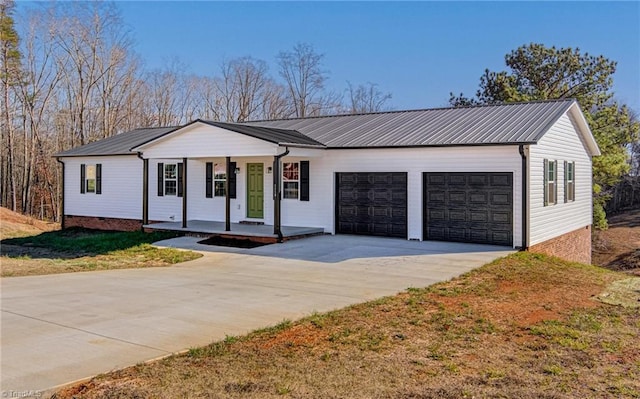 ranch-style home featuring a garage, covered porch, and a front lawn