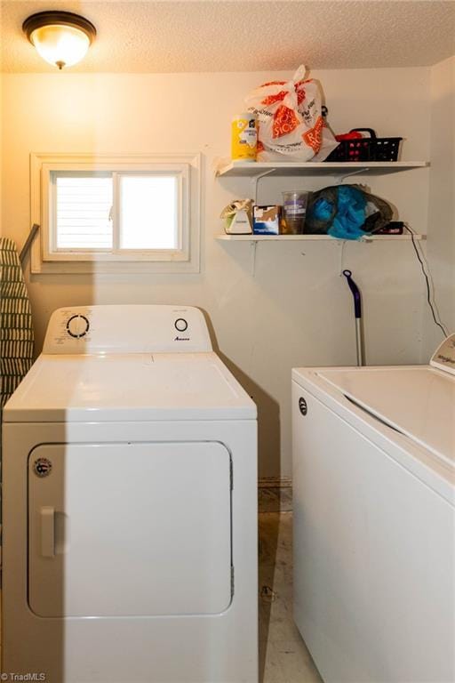 laundry room featuring independent washer and dryer and a textured ceiling