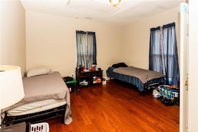 bedroom with dark hardwood / wood-style floors