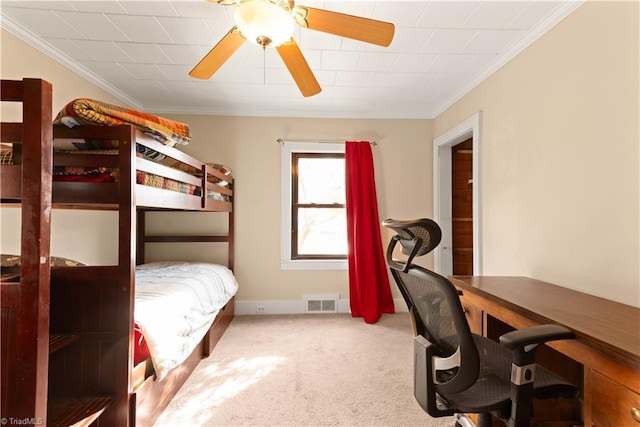 carpeted bedroom with ceiling fan and crown molding