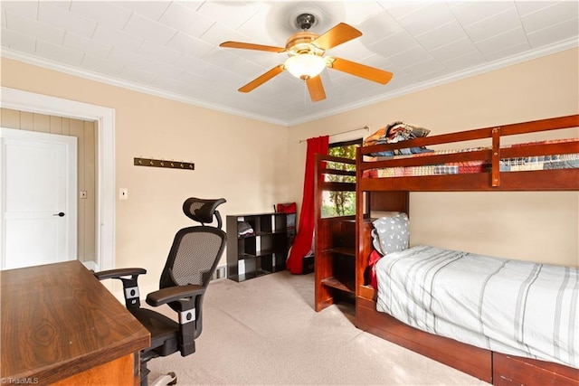 bedroom with ceiling fan, crown molding, and carpet