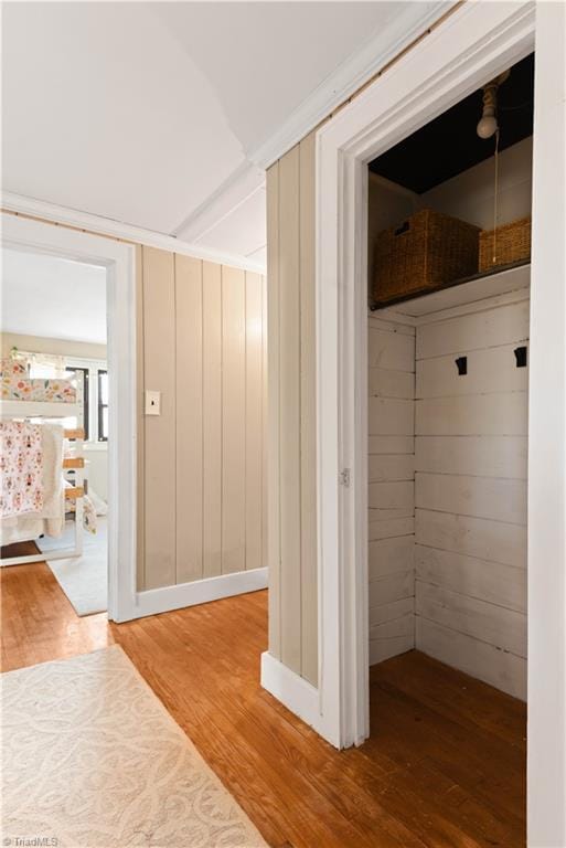 mudroom featuring wooden walls and wood-type flooring