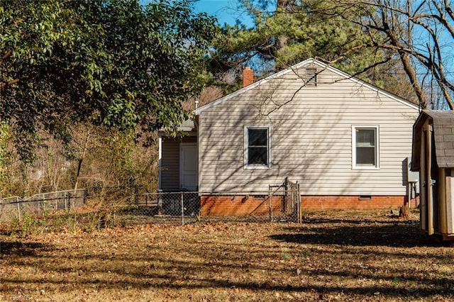 view of side of property featuring crawl space and fence