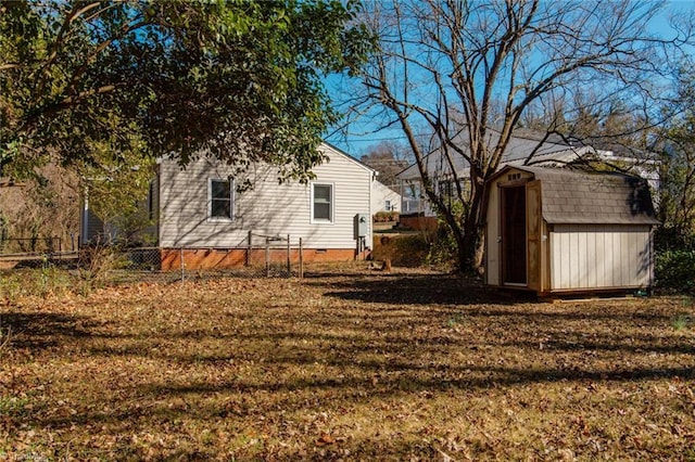 view of yard with an outbuilding, fence, and a storage unit