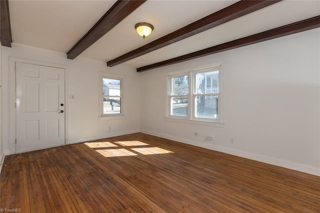 empty room with baseboards, beamed ceiling, and hardwood / wood-style floors