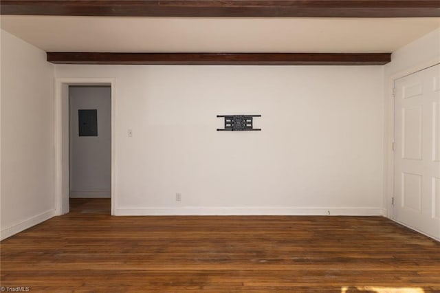 empty room with dark wood finished floors, beamed ceiling, and baseboards