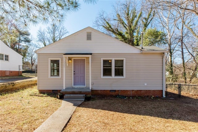 view of front of home with crawl space and fence