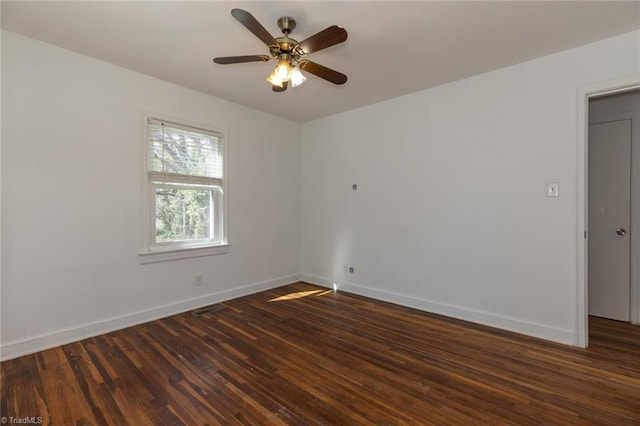 spare room with ceiling fan, baseboards, and wood finished floors