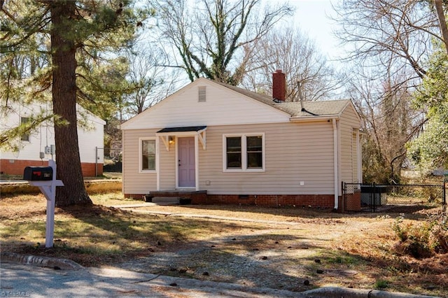 view of front of property featuring crawl space, a chimney, and fence