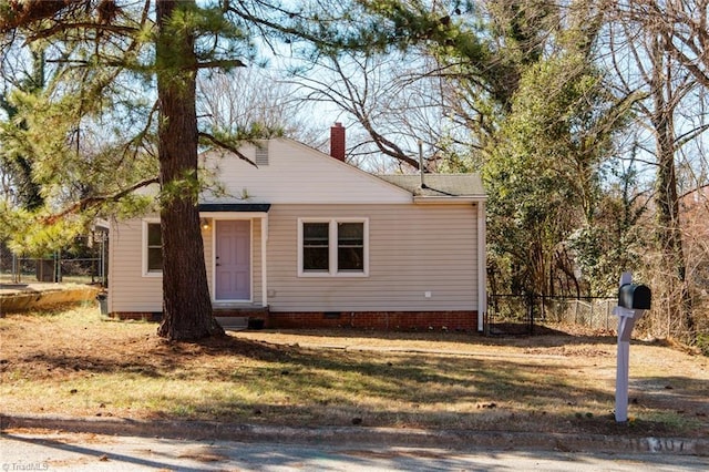 view of front of home featuring crawl space, a chimney, and fence