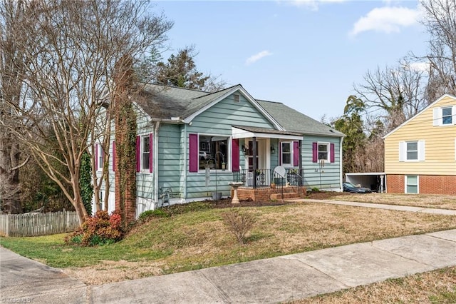 bungalow featuring a chimney, fence, and a front yard