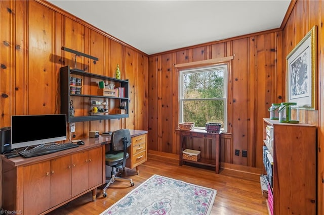 office space featuring wood walls and light wood-style floors