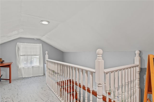 corridor featuring vaulted ceiling, carpet flooring, and an upstairs landing