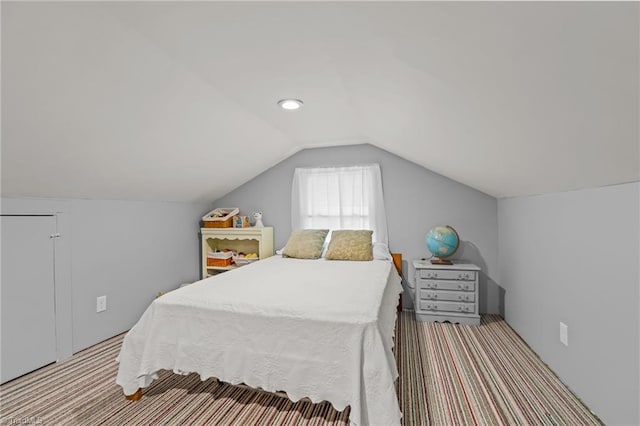 bedroom featuring lofted ceiling and carpet flooring