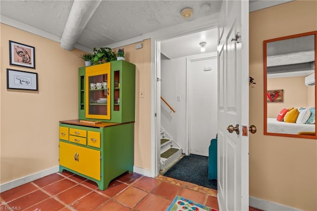 rec room with a textured ceiling and baseboards