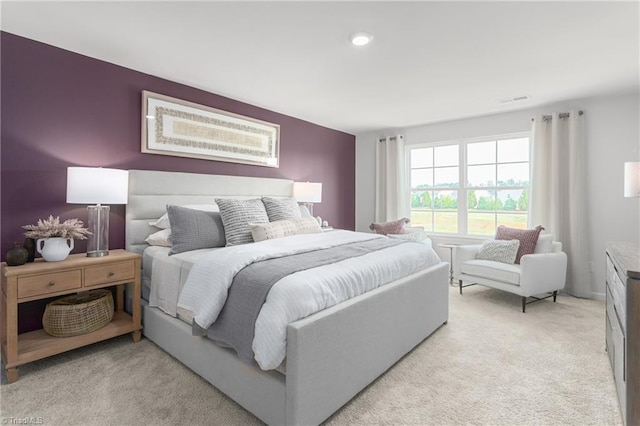 bedroom featuring light carpet